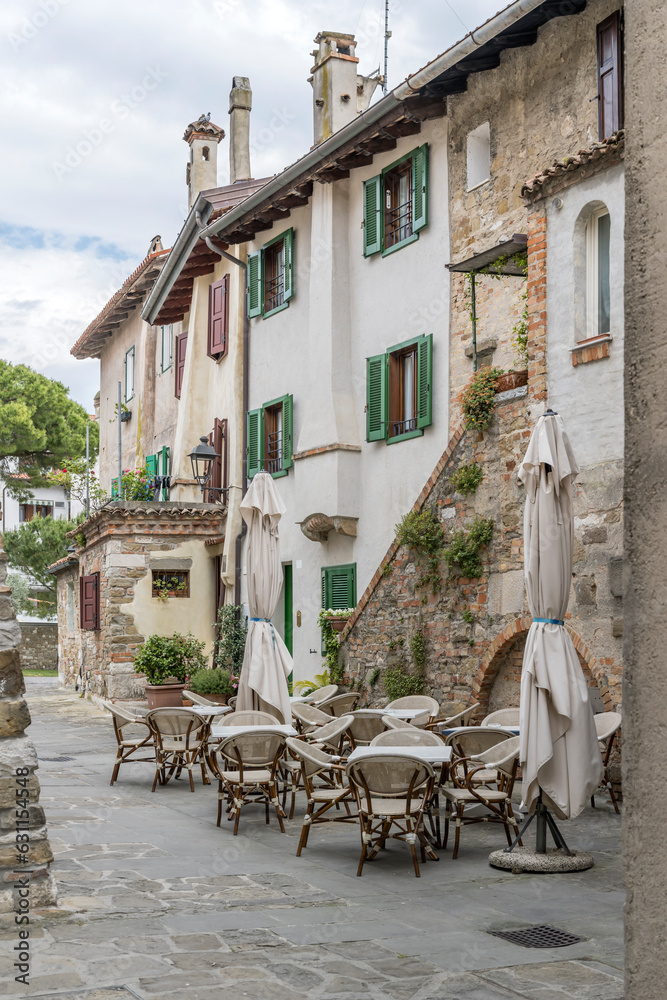 empty tables and picturesque old buildings, Grado, Italy