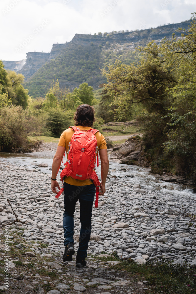 Young mountaineer man, trekking in the Delika canyon, Alava, near the source of the Nervio waterfall