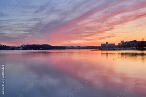 Idyllic scene of Stockholm cityscape on the shore at sunset in Sweden © Pekka/Wirestock Creators