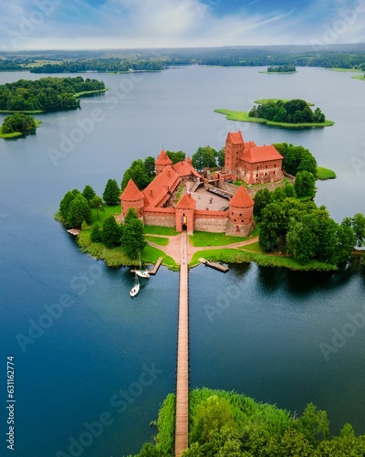 Aerial view of the Trakai castle surrounded by trees over the Galves Lake in Trakai, Lithuania