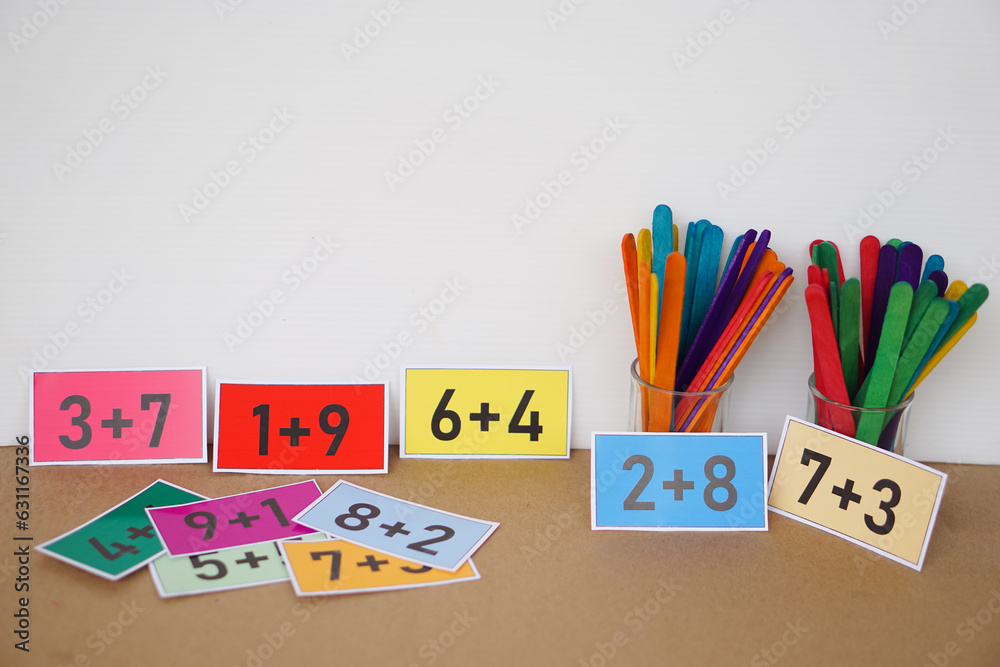 Colorful cards with numbers plus , addition on cards and colorful sticks for counting for kids. Concept, teaching aid, materials for Math subject. Education. Colorful cards with numbers plus , addition on cards and colorful sticks for counting for kids. Concept, teaching aid, materials for Math subject. Education.