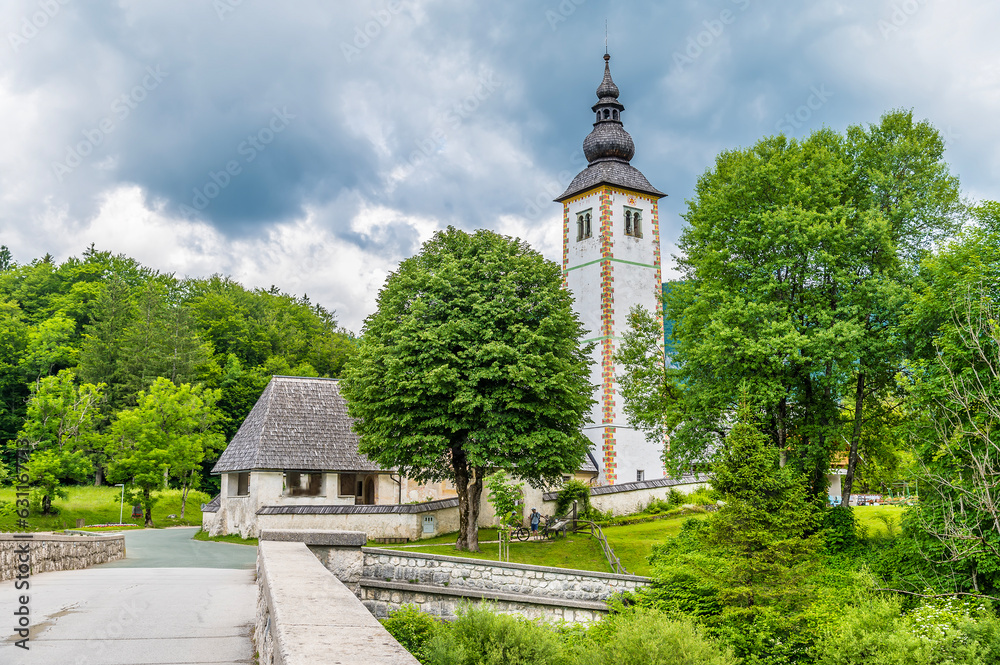 Fototapeta premium A view from Bohinjsko Jezero towards the church of Saint John the Baptist in Slovenia in summertime