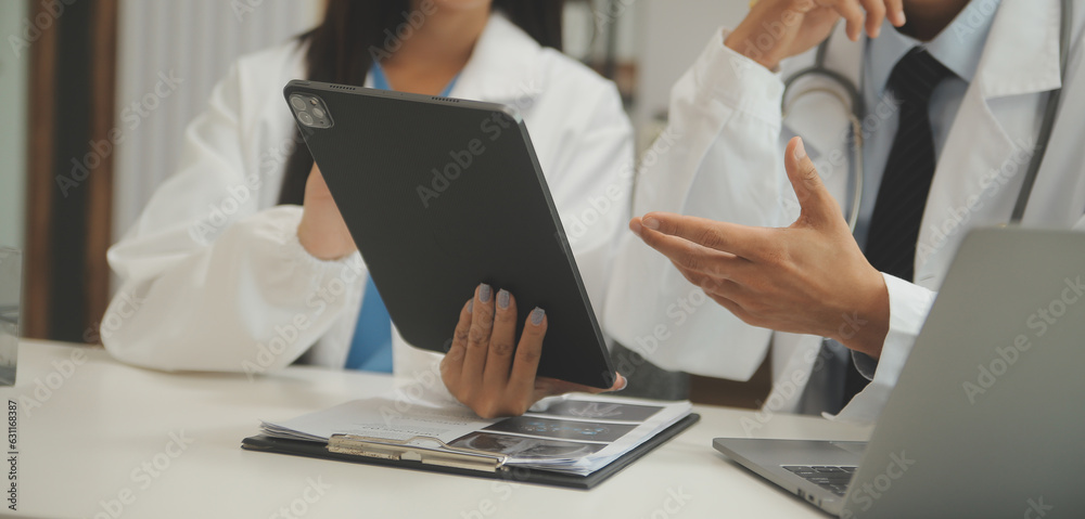 Confident doctor man holding a pill bottle and writing while talking with senior patient and reviewing his medication at office room. Confident doctor man holding a pill bottle and writing while talking with senior patient and reviewing his medication at office room.
