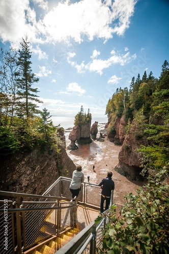 Picturesque scene of tourists enjoying Hopewell Rocks Provincial Park in the Bay of Fundy, Canada