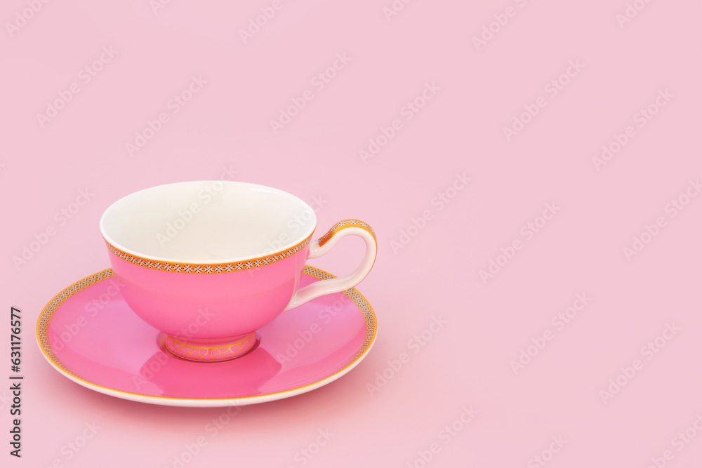Pink and gold bone china tea cup. Elegant luxury drinking set on pastel pink background with copy space. Minimal zen composition. Pink and gold bone china tea cup. Elegant luxury drinking set on pastel pink background with copy space. Minimal zen composition.