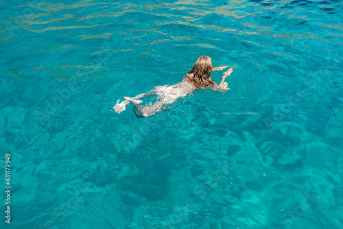 Im Urlaub nackt im kühlen türkisen Meer schwimmen.