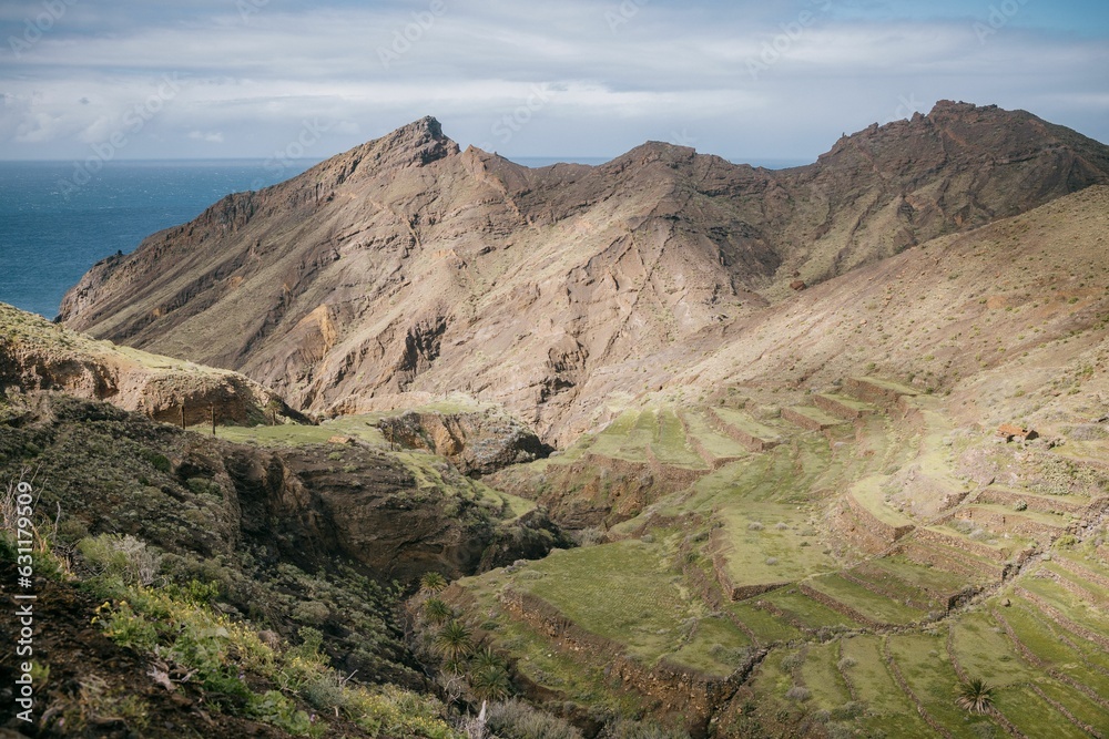 View of the mountains near to some water and grass on a mountain, La Gomera, Spain, Canary Islands