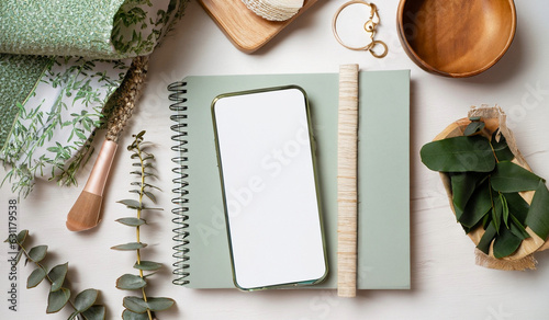 Feminine Smartphone Mockup on White Boho Styled Desk with Mint Notebook and Eucalyptus stock images 