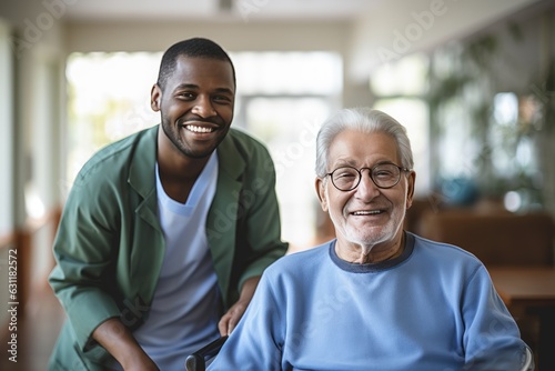 Senior man in a nursing home with his caretaker next to him smiling © NikoG