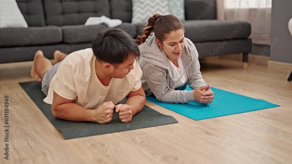 Man and woman couple training abs exercise at home Man and woman couple training abs exercise at home