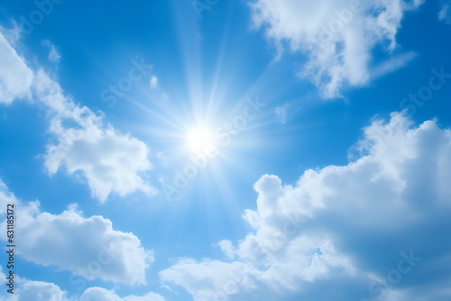 blue sky with fluffy white clouds and sun with lens flare