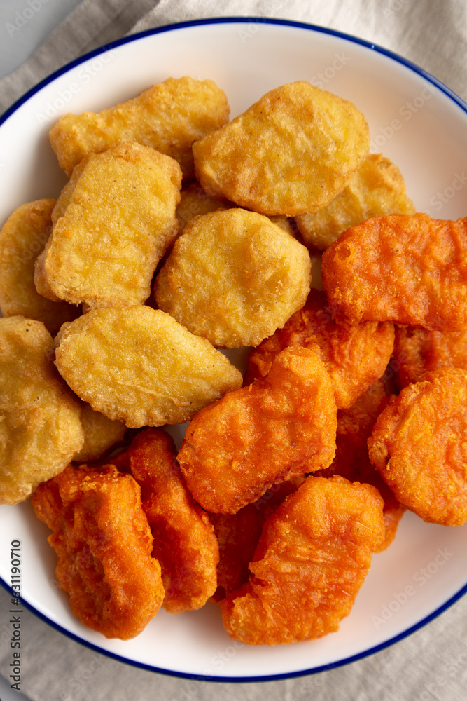 Homemade Spicy Chicken Nuggets Mix on a Plate, top view. Close-up. Homemade Spicy Chicken Nuggets Mix on a Plate, top view. Close-up.