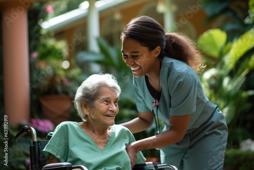 Senior woman and her female caretaker in a nursing home smiling photo