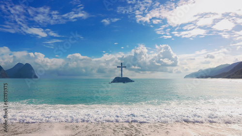 Christ Cross on an island in the middle of the open sea. Concept for faith, power, worship, Cristianity and Easter photo