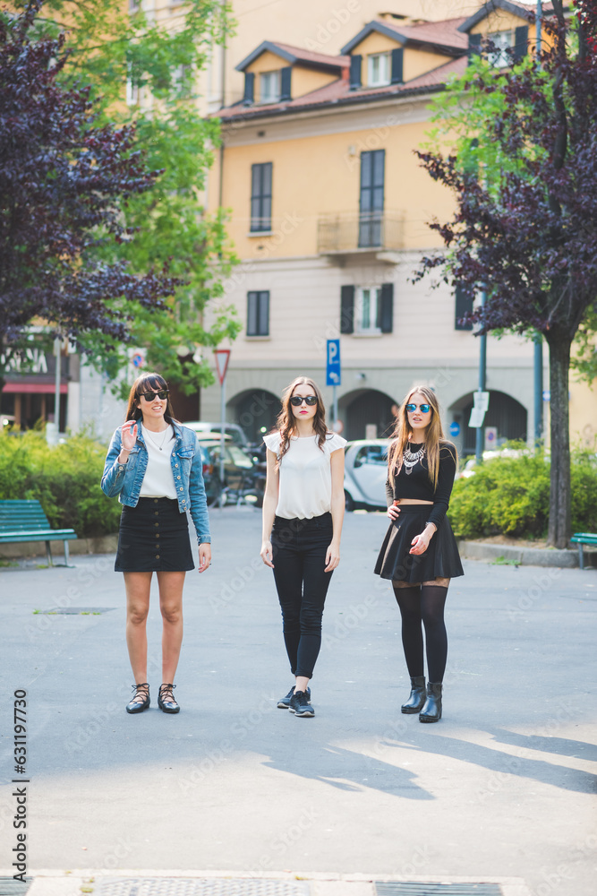 Three young happy women friends posing outdoors having fun Three young happy women friends posing outdoors having fun