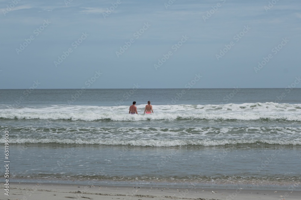 People swimming in the beautiful blue ocean of Myrtle Beach, South Carolina People swimming in the beautiful blue ocean of Myrtle Beach, South Carolina