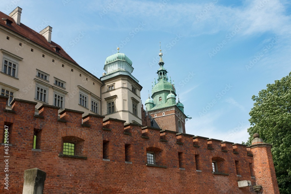 Wavel royal castle with brick walls in Krakow, Poland against a blue sky