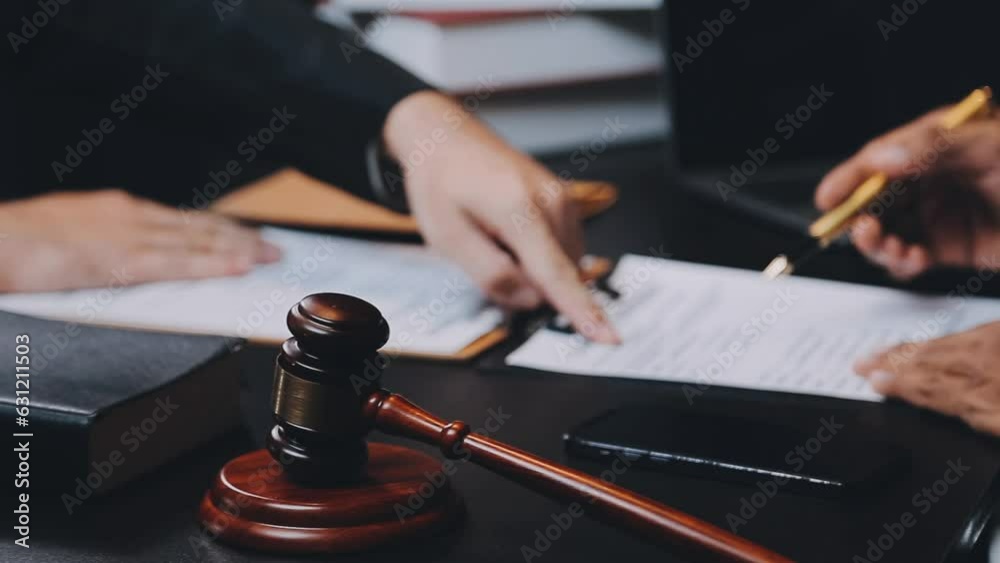 Business and lawyers discussing contract papers with brass scale on desk in office. Law, legal services, advice, justice and law concept picture with film grain effect Business and lawyers discussing contract papers with brass scale on desk in office. Law, legal services, advice, justice and law concept picture with film grain effect