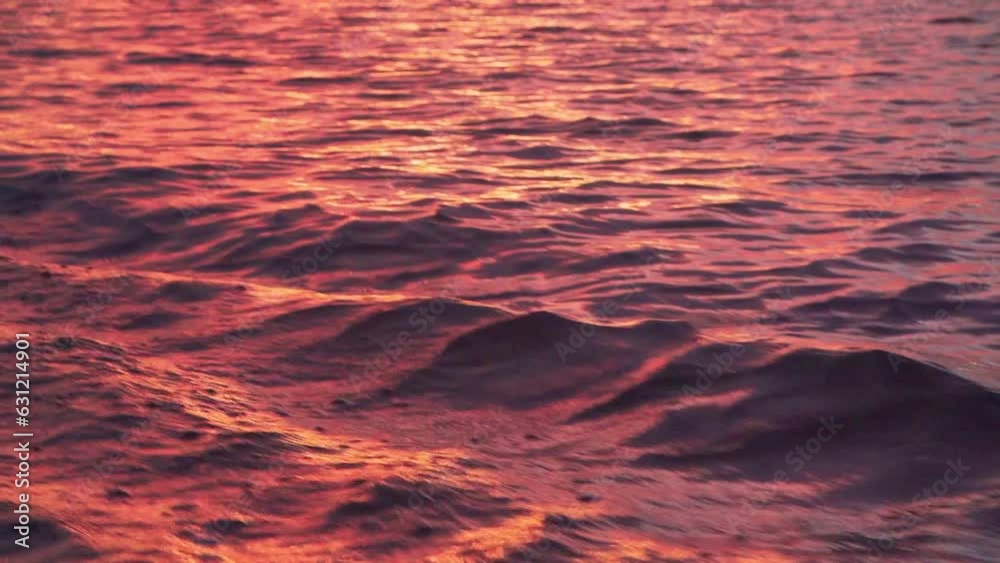 Slow-motion view from a boat driving on a wavy lake during a vibrant sunset Slow-motion view from a boat driving on a wavy lake during a vibrant sunset