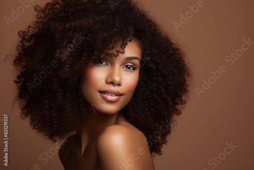 Clean healthy skin, smiling dreamy black woman, afro-style curly hair, beauty portrait on beige background.