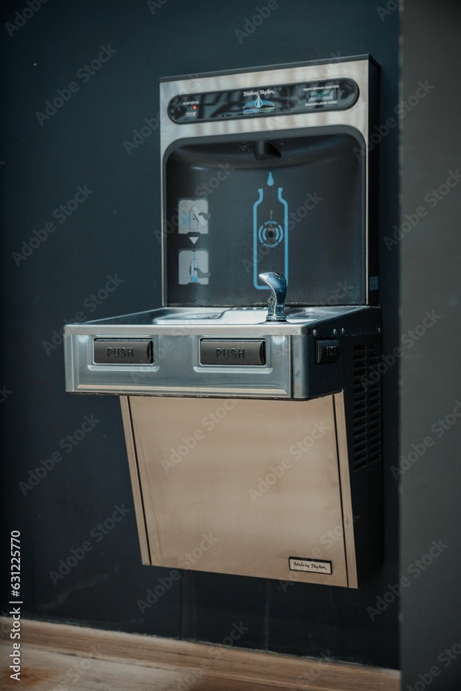 Water machine with two open doors revealing a stove below Water machine with two open doors revealing a stove below