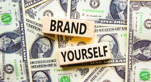 Brand yourself symbol. Concept words Brand yourself on beautiful wooden block. Beautiful background from dollar bills. Dollar bills. Business brand yourself concept. Copy space.