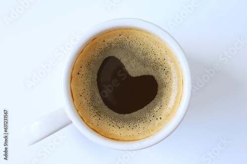 Cup of black coffee with lovely heart shaped froth isolated on white background © jobi_pro