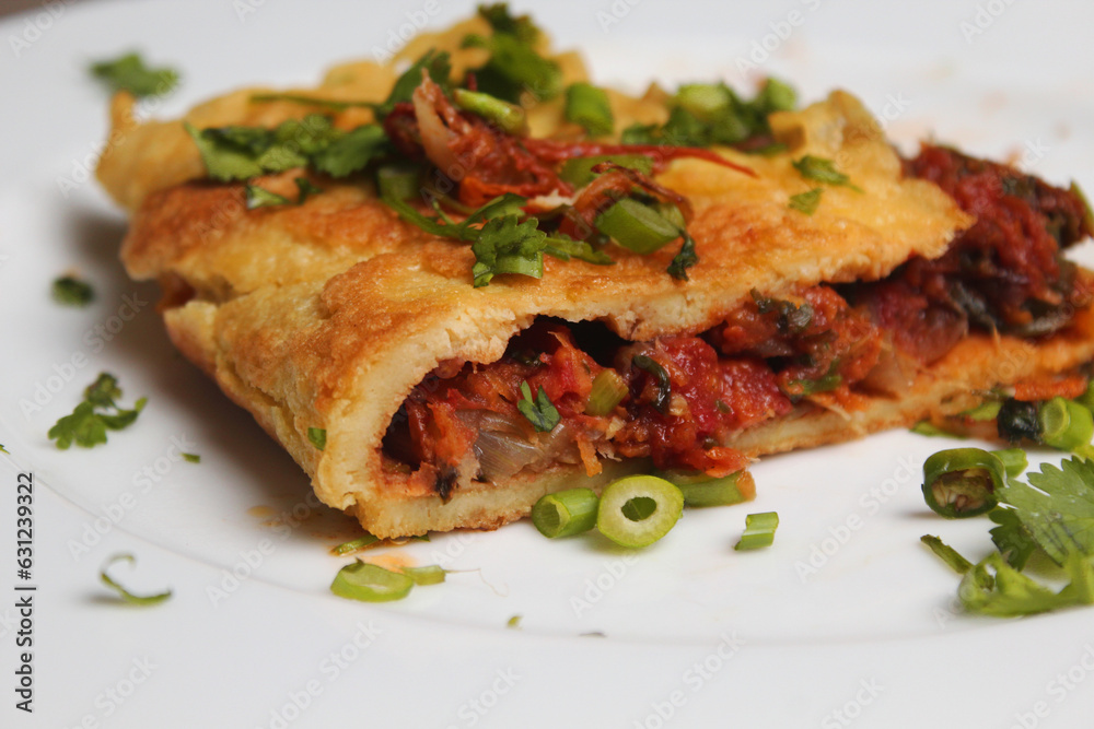Close view of A piece of Egg omelet into the white plate. Close view of A piece of Egg omelet into the white plate.