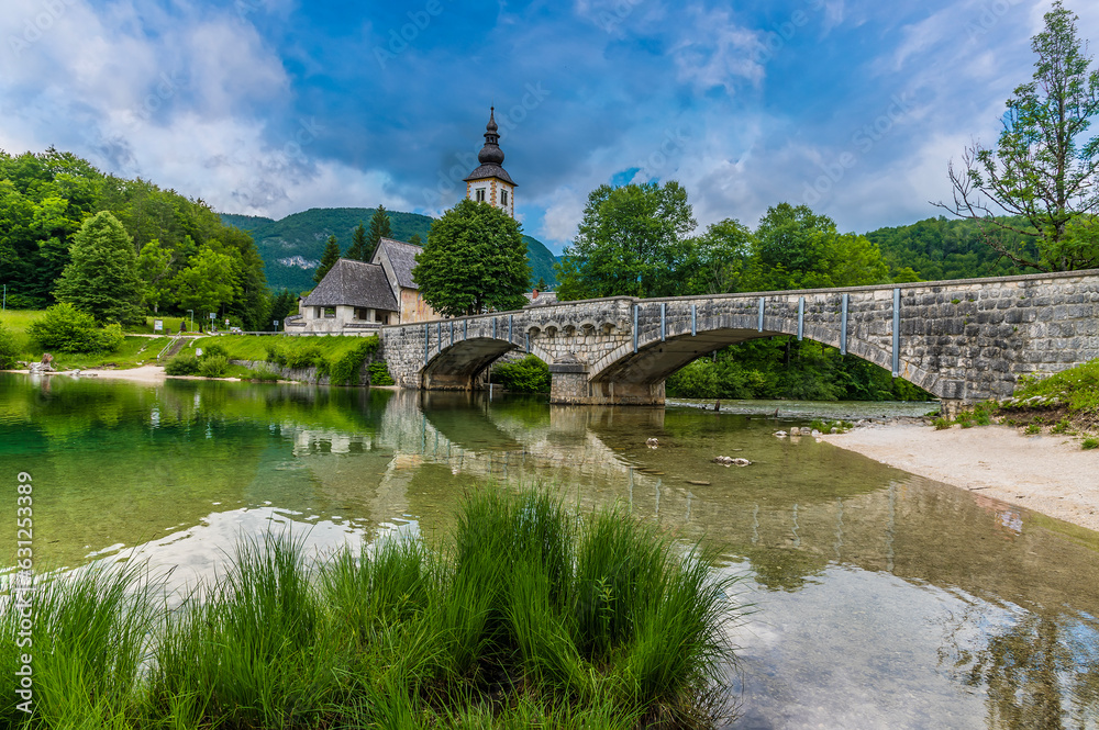 A view towards the bridge at Bohinjsko Jezero on Lake Bohinj, Slovenia in summertime