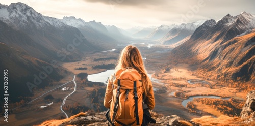 Woman with backpack taking a view in the mountains