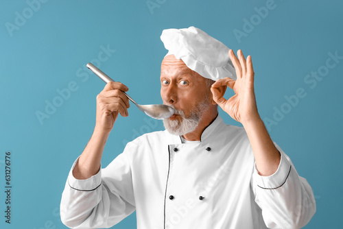Mature chef with ladle gest...
