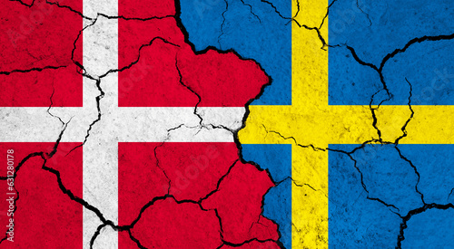 Flags of Denmark and Sweden on cracked surface - politics, relationship concept