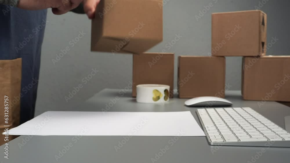 The packer in the warehouse sends a gift to the buyer through the online store. E-commerce, delivery of goods, brown boxes for goods The packer in the warehouse sends a gift to the buyer through the online store. E-commerce, delivery of goods, brown boxes for goods