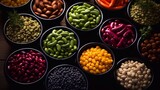 Colorful different beans in bowls on dark background, top view. AI generation