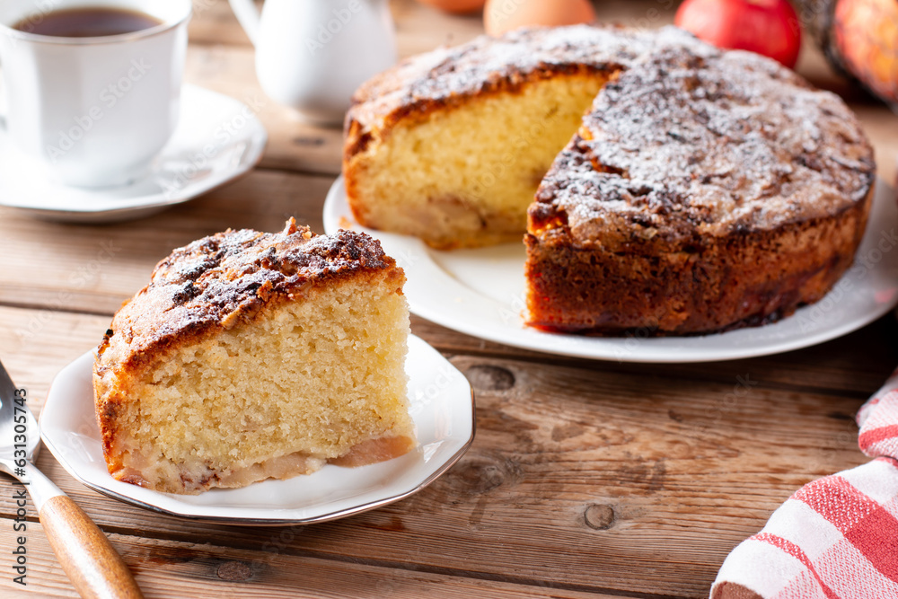 Sponge cake with apples on a table, selective focus. Homemade cake