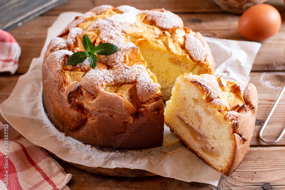 Sponge cake or chiffon cake with apples, so soft and delicious with ingredients: eggs, flour, apples on wooden table. Homemade bakery concept for background and wallpaper.