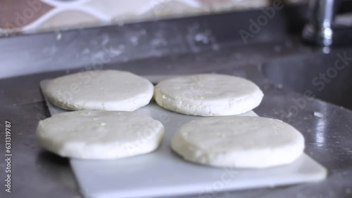 Colombian arepa prepared ready to cook on a stove in a kitchen photo