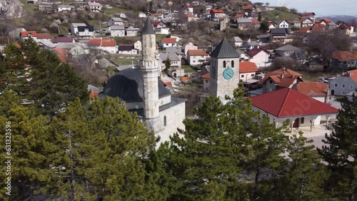 Aerial View of Old Clock Tower and Mosque Behind the Trees in Livno, Bosnia - 4K photo