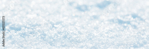 Snow surface close-up. Winter background with snow texture and beautiful bokeh. Shallow depth of field and blur. Perfect for Christmas and New Year design. View with copy space.