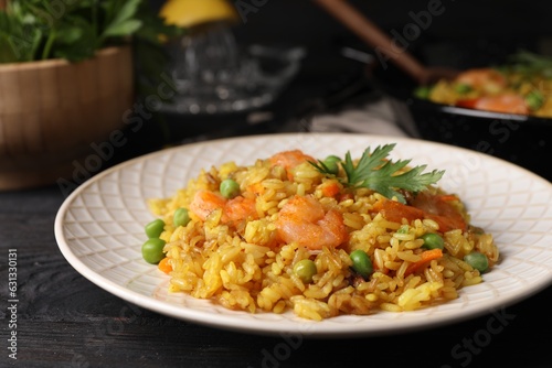 Tasty rice with shrimps and vegetables on dark wooden table, closeup