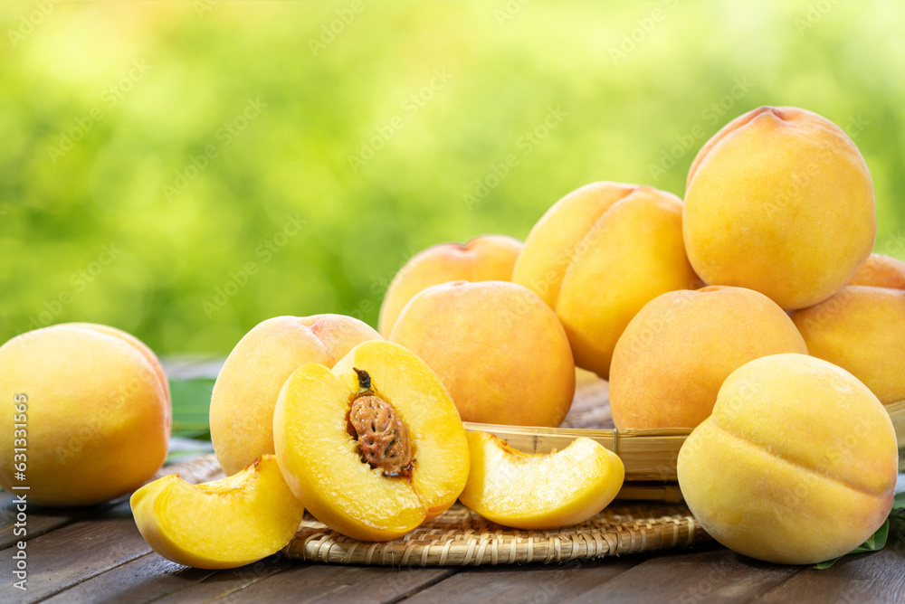 Yellow Peach fruit on wooden basket in garden background, Fresh Yellow Peach.