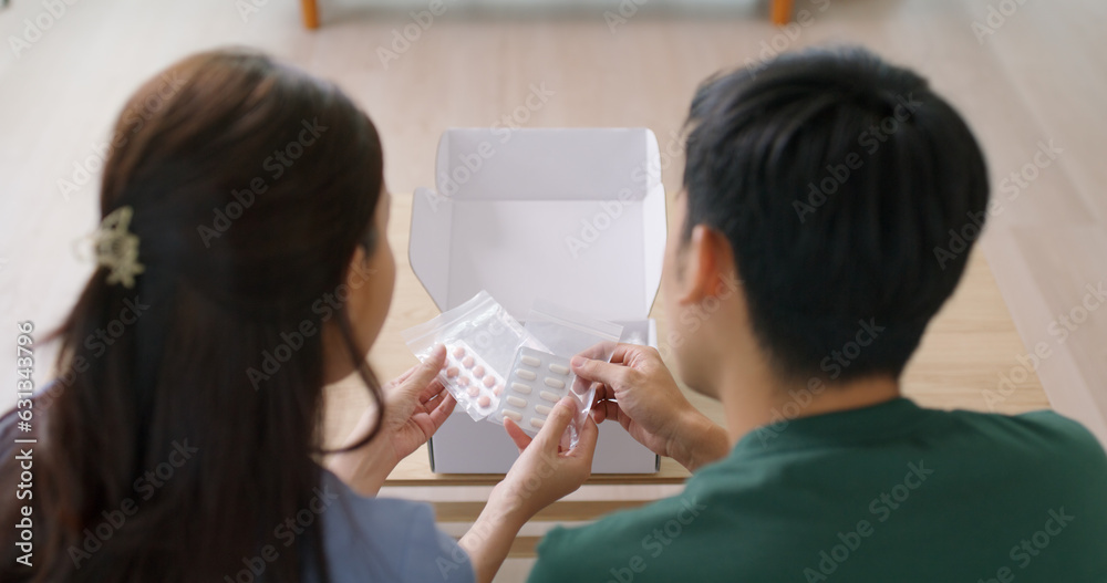 Young married asia people prepare pregnant plan preconception drug at home sofa. Health care unbox open Rx mail parcel covid first aid kit box self cure buy pill order online by clinic service store. Young married asia people prepare pregnant plan preconception drug at home sofa. Health care unbox open Rx mail parcel covid first aid kit box self cure buy pill order online by clinic service store.