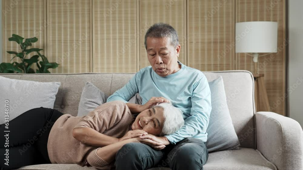 Lovely senior couple spending time together on the sofa, wife lying on husband lap happily. Lovely senior couple spending time together on the sofa, wife lying on husband lap happily.