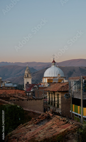 Beautiful view of a sunset of the bell tower and dome of the cathedral of Jauja, can see the old houses around. photo