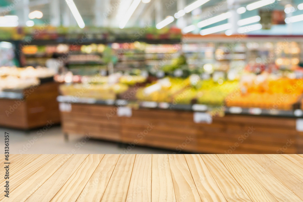 Fototapeta premium Empty wood table top with supermarket blurred background for product display