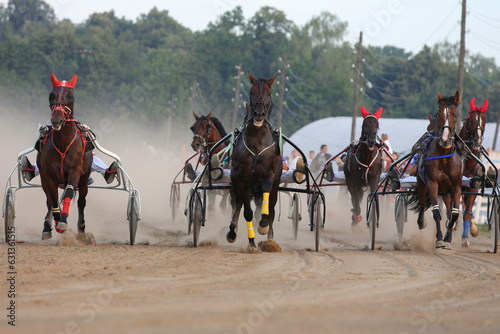 Horses and riders running at horse races