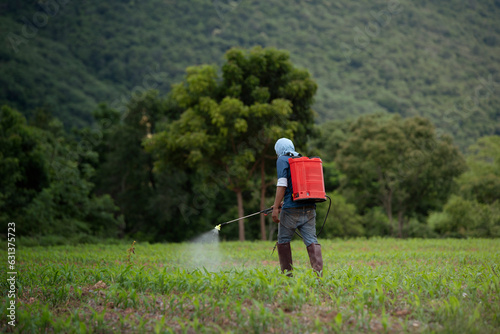 Obraz na plátně farmer spraying pesticide in farmland