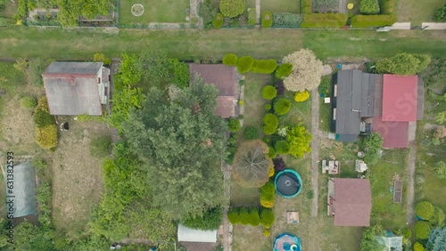 Drone view of allotment gardens, a resting place for people outside the city. View from the air on people resting on the plots.