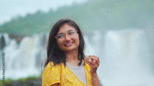 Portrait of beautiful Indian girl Standing against Gira waterfall at Waghai, Gujarat, India. Smiling woman enjoying vacation. Indian ethnic woman. photo