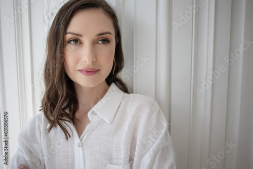 Stylish and beautiful lady in white, calm smile, close-up portrait,
